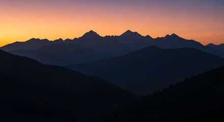 Fototapeta premium Mountain range silhouetted against a vibrant sunrise