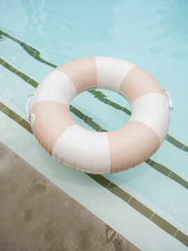 Floating Ring Rests Beside a Calm Swimming Pool