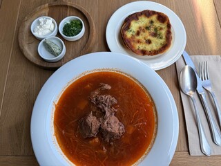 Traditional borscht with beef and side dish