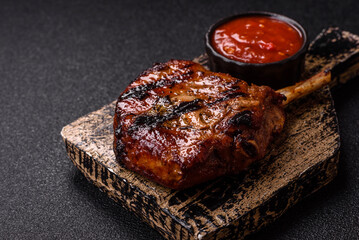 Steak, beef or pork on the bone, meat cooked on the grill with rosemary. Steak on the bone