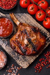 Steak, beef or pork on the bone, meat cooked on the grill with rosemary. Steak on the bone