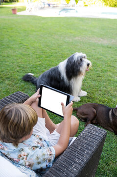 Child using app to control smart collar for pet wellness