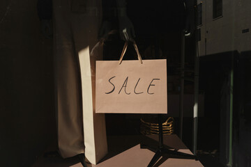 Sale Sign Displayed in a Store Window During Evening Hours