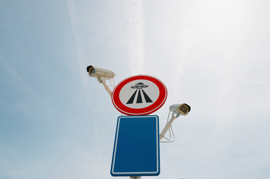 Unusual Road Sign Indicating UFO Activity and Surveillance Cameras