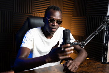 Content creator recording audio podcast using microphone