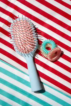 Still life with Colorful Hair Accessories on a Striped Background.