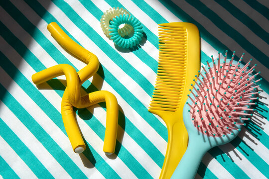 Still life with Colorful Hair Accessories on a Striped Background.