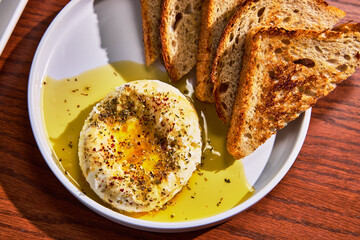 Artesian Bread & Cheese Plate with Olive Oil and Herbs on White Plate 