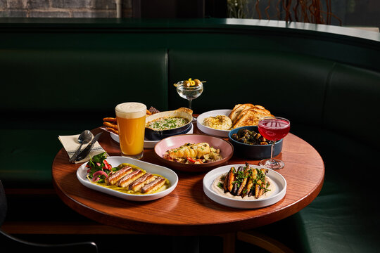 Chic Bistro Dining: Full Table with Vegetarian Dishes and Fish