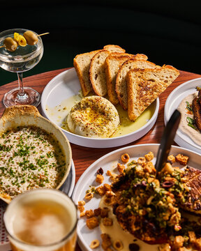 Close-Up of Martini with Olives, Roasted Cauliflower, and Bread.