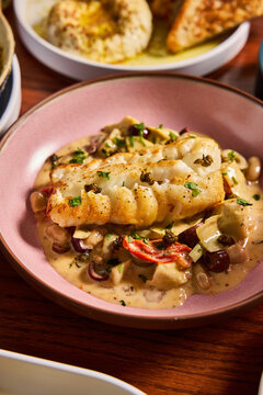 Pan-Seared Perfection: Cod in a Creamy Mediterranean Medley