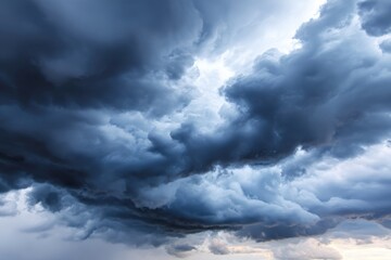 Dramatic storm clouds gathering over the horizon, showcasing dark, swirling formations with contrasting light, creating an intense and atmospheric scene of impending weather
