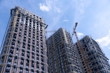 New urban buildings rise against a clear blue sky in the city