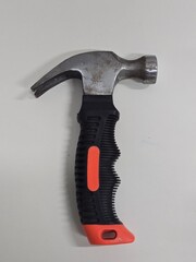 Claw hammer with black and orange handle isolated on white background