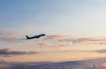 Airplane that just took of to the beautiful sunset sky. Transportation