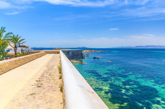 Defense town walls of Tabarca Island Nueva Tabarca Isla Plana village town and azure water of Mediterranean Sea Alicante bay in sunny summer day, Alicante province, Valencian Community, Spain