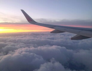 Fototapeta premium Airplane wing over a colorful sunset view of clouds