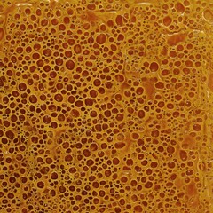Obraz premium Abstract Golden Honeycomb: A high-angle shot captures the mesmerizing texture of abstract honeycomb, highlighting the golden hues and intricate cellular structure in this macro shot.
