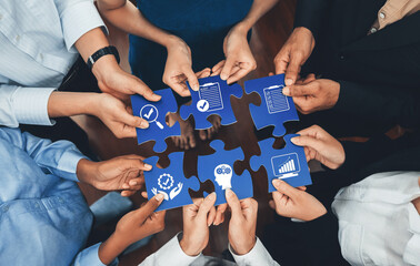 A diverse group of professionals collaborates with puzzle pieces, symbolizing strategy, planning, and growth, in a dynamic and engaging business environment. Amity