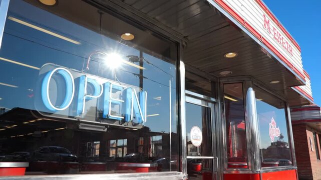 Classic American Diner Open Sign on Sunny Day - A classic American diner's exterior is shown on a sunny day, with its "OPEN" sign visible in the window.