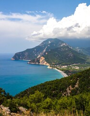 Coastal mountain vista, hazy, turquoise water