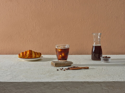 Minimalist Coffee Setup With Croissant and Cold Brew