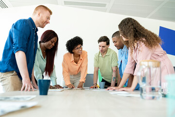 Multicultural team working together on a project in modern office