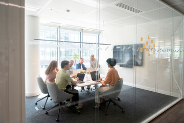 Business team collaborating on project in modern office meeting room