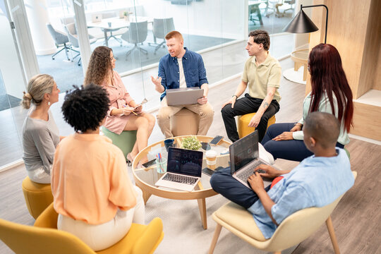 Multicultural team collaborating during office meeting - Powered by Adobe