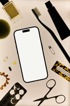 Flat lay of smartphone with personal care items 