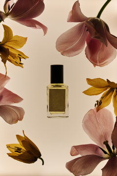 Perfume bottle mockup surrounded by flower petals