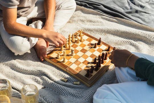 Mother and Son Playing Chess During a Family Picnic