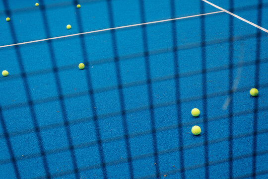 Green Tennis Balls Scattered on Blue Court Surface During Practice