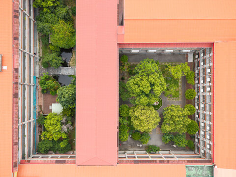 Aerial School Courtyard with Trees and Pond View