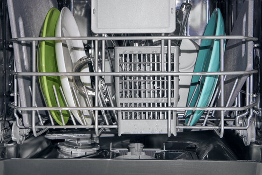 Dishwasher Filled With Clean Plates and Utensils