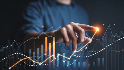 Businessman's hand touching a glowing upward trending financial graph with data visualization finance
