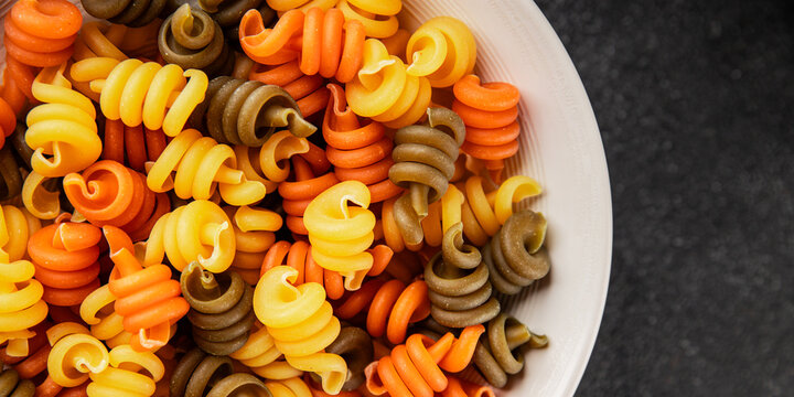 pasta trottole tricolor pasta spiral dish twisted Italian food tasty snack fresh delicious gourmet food background on the table rustic top view copy space  vegan and vegan food