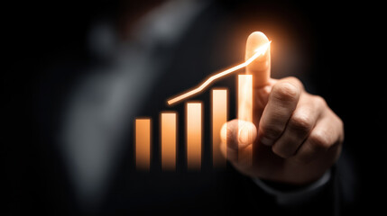 Businessman pointing at glowing upward graph, symbolizing growth and success in finance and investment. image conveys sense of achievement and progress