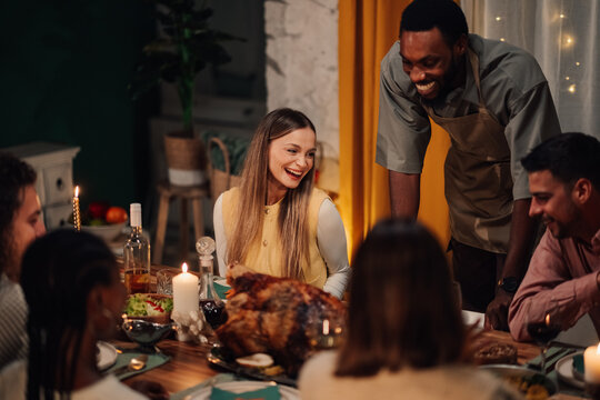 Friends enjoying thanksgiving dinner together at home