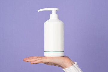 Female hand with white bottle