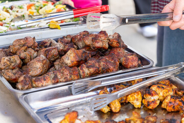 Metal trays with aromatic roasted kebab