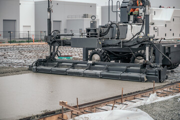 Worker on Concrete Pour Process on a Construction Site