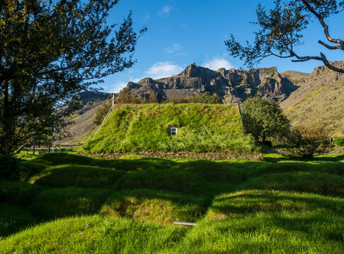 Green roof of traditional turf church in Hof, Iceland - Powered by Adobe