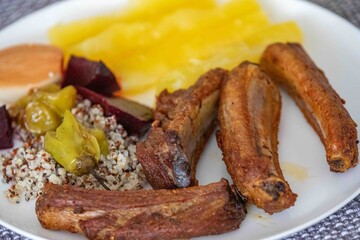 healthy superfood well balanced in nutrients, roasted pork chops,cassava, quinoa, salad, vegetables