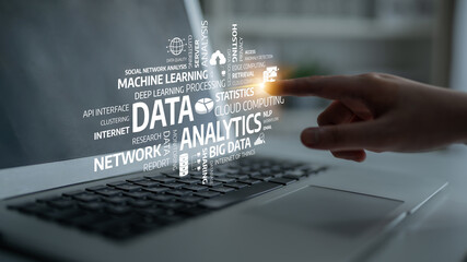 Explore the interaction of a person using data analytics concepts on a laptop, showcasing essential technology terms in a modern office environment. Tessel