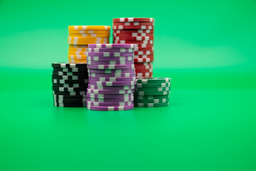 Chips on green background, symbolizing casino games, gambling, and poker tournaments.