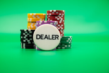 Poker chips, dice, and dealer button on green background, symbolizing casino games, gambling, and poker tournaments.