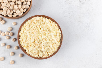Lupines flour in a wooden bowl on a gray background. Gluten-free, protein-rich food. Top view.