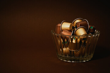 A glass bowl full of espresso capsules
