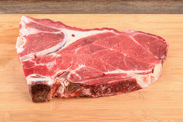 A piece of raw beef or veal meat on the bone.